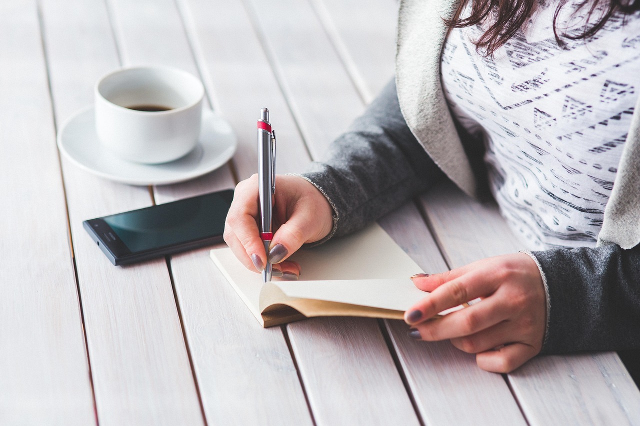 Woman, write, notepad — Gary Guglielmo: Crafting Your Journey to Financial Prosperity